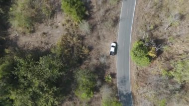 Drone 'un hava görüntüsü kurak mevsimde kırsal alanda terk edilmiş kamyonet yolu manzarası.