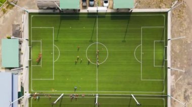 İnsansız hava aracı görüntüleri birçok insanın hava görüntüsü suni çim futbol sahasında spor yapıyor.