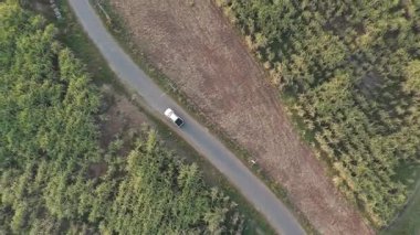 İnsansız hava aracı görüntüleri kırsal kesimde kurak mevsimde terk edilmiş bir yolda kamyonet sürerken görüntüler.