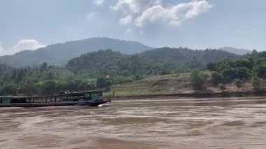 Mekong Nehri boyunca Laos 'ta tekne taşımacılığı, köyleri birbirine bağlamak, malları taşımak ve manzaralı turlar sunmak için gereklidir. 4k video kaydı