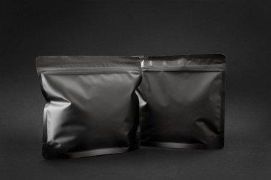 Premium spesiyal kahve modeli, iki koyu paket. Marka şablonu ve sunum tasarımı için boş etiketli folyo poşeti.