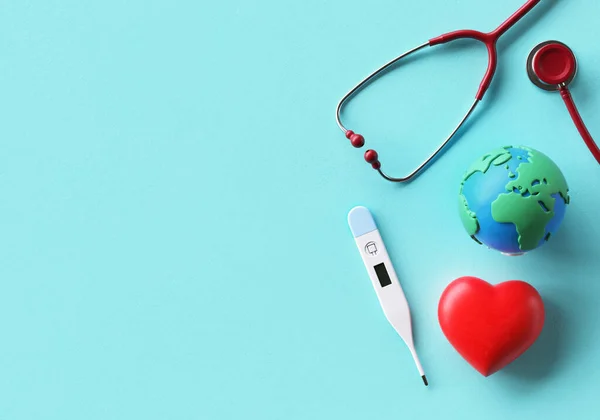 World Health Day background template with doctor stethoscope, heart, thermometer and Earth in flat lay and copy space, 3D rendering. Global health awareness day celebrated every year on 7th April