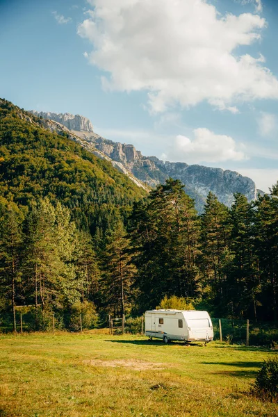 Caravan with amazing landscape views of forest and mountains. Camping holiday and outdoor summer vacation. Nomad lifestyle concept