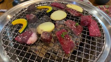 Japon Yakiniku Barbekü 'nün 4k video görüntüleri Kömür Izgarasında Çeşitli Biftek Kesikleri ve Sebzeler 