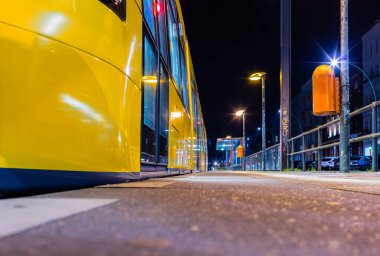 Berlin: modern tram streetcar stops at night / clean streetcar station / Trolley Metrotram / Metro Tram local transport berlin, berlin stop modern streetcar, city center, at night at night last streetcar bvg clipart