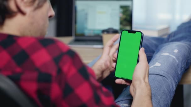 Man Using Smartphone Vertical Mode Green Mock Screen Doing Swiping — Stockvideo