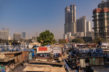 Incredible view of the Dhobi Ghat in Mumbai, the largest open-air laundry in the world. Impressive social contrast with skyline skyscrapers.