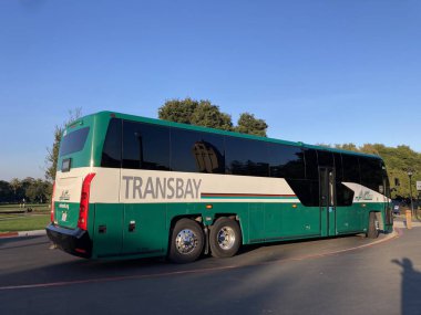 MCI D45 CRT LE transit coach bus in green and white colors operated by AC Transit. Side rear view - Palo Alto, California, USA - December 19, 2024 clipart