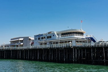 A side view of Santa Cruz Wharf with Stagnaro Bros seafood restaurant. - Santa Cruz, California, USA - July 6, 2024 clipart