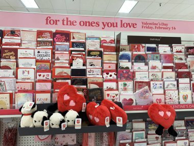 Valentine's Day store display featuring greeting cards, plush heart toys, and stuffed animals, with a pink banner reading : for the ones you love - California, USA - January 29, 2025 clipart