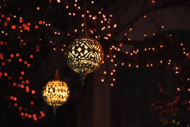 Christmas decorations glowing outside at night in front of a house. Christmas lights