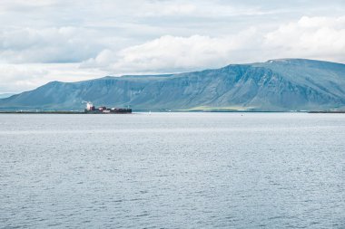 Reykjavik, Iceland - July 11, 2022: Container ship arriving to the shore. Vessel of Eimskip, shipping company in Iceland