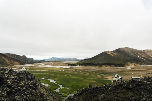 Icelandic landscape of Landmannalaugar with camping site and huts for hikers and adventures