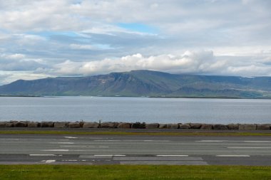 View of mountains, water and street in Reykjavik, Iceland