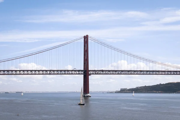 stock image The 25 April Bridge or Ponte 25 Abril located in Lisbon, Portugal. First suspension bridge over Tagus River