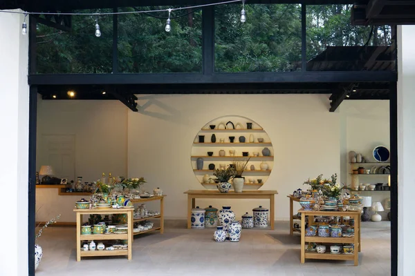 Inside store with retail sale of ceramic and porcelain pots, planters and vases