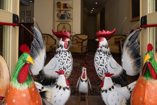 Decorative metal roosters at the entrance of the store or an apartment