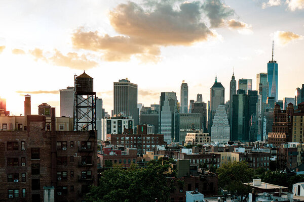 View of financial district Manhattan skyline and Brooklyn buildings at sunset