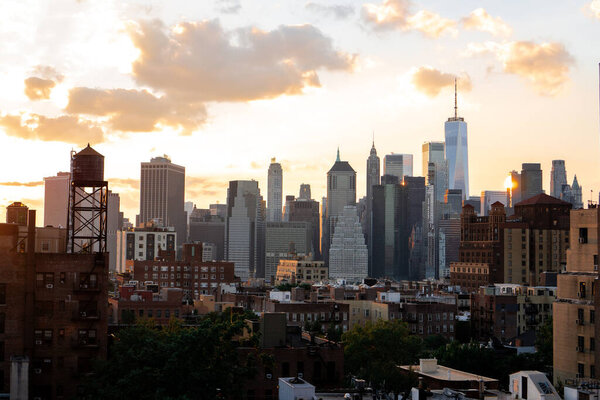 View of financial district Manhattan skyline and Brooklyn buildings at sunset