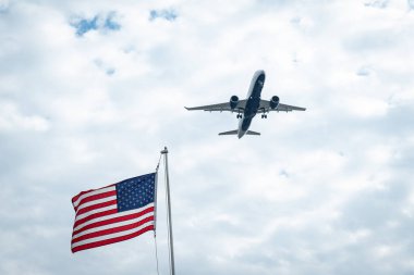 Amerikan bayrağının arka planında gökyüzünde uçan uçaklar