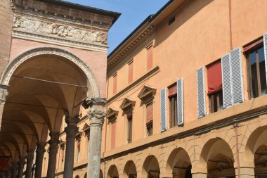 Bologna is full of picturesque, brightly colored buildings, especially red ones. In fact, Bologna is the red city in whose streets full of arcades one walks pleasantly. clipart