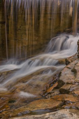 Kananaskis, Alberta, Kanada 'da sinekkuşu dumanlı gözcü yürüyüşündeki su ölçüm istasyonunda küçük bir şelale.