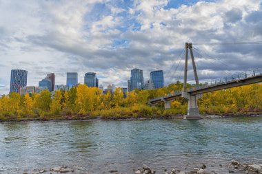 Bow nehrinin sonbahar manzarası ve Calgary şehir merkezindeki Prince 's Island Köprüsü arka planda Alberta, Kanada
