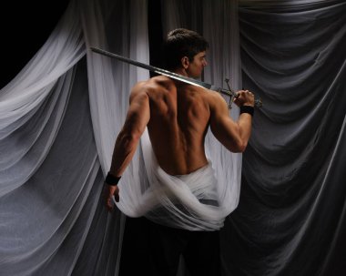seksi adam bir kılıç tutuyor