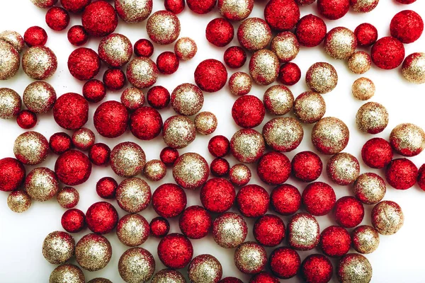 Shiny gold and red balls over white background. Cristmas greeting card