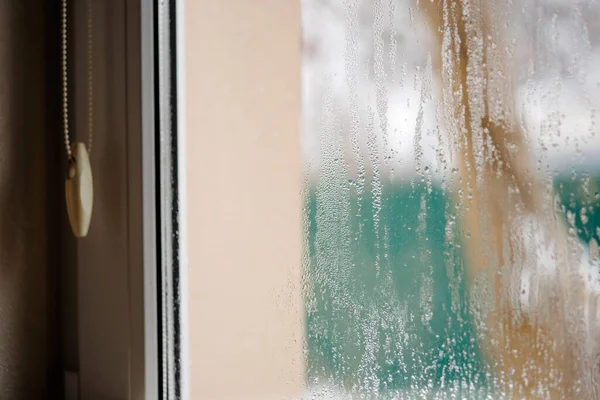 stock image Condensation droplets on plastic window glass from temperature changes. 