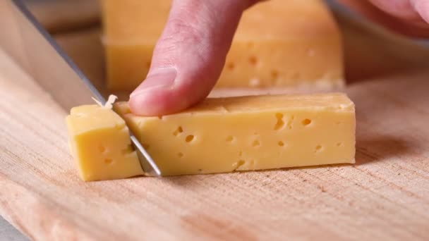 Knife Mans Hand Cuts Yellow Cheese Holes Cubes Slices — Stock video