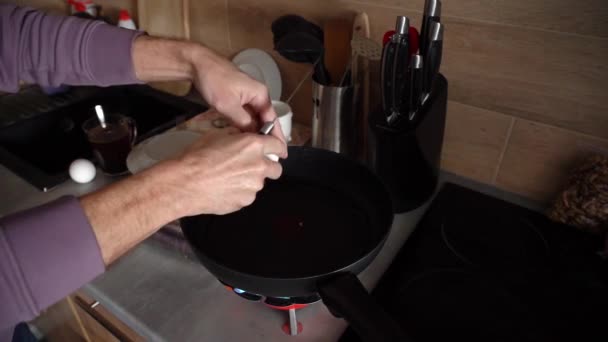 Man Cooks Eggs Frying Pan Which Stands Portable Gas Burner — Video Stock