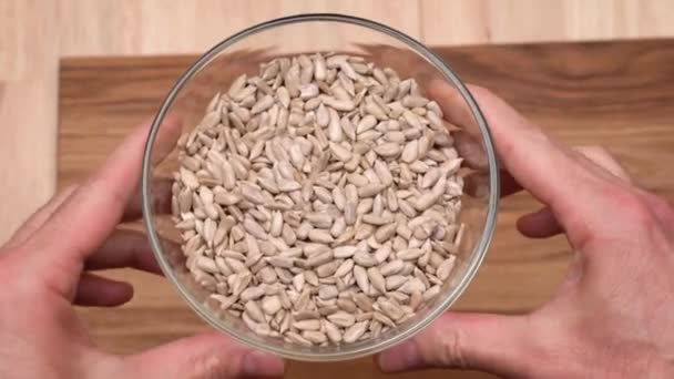 Mens Hands Hold Glass Bowl Peeled Sunflower Seeds Rotate — Stock video