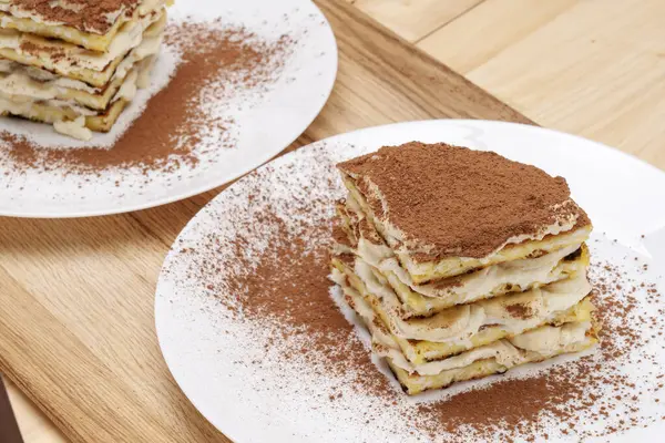 A piece of homemade layer cake, banana with cocoa, on a white plate.