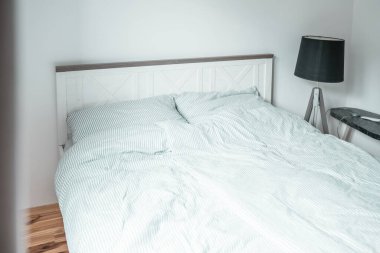 Bed with pillows in a bedroom. Minimalistic bedroom interior.	