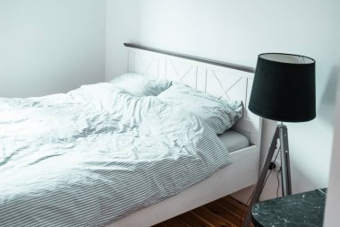 Bed with pillows in a bedroom. Minimalistic bedroom interior.	