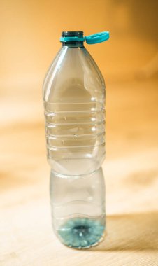 Plastic cap connected to a plastic bottle. Bottle design with the cap attached to the bottle for easier recycling of waste.	