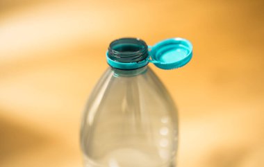 Plastic cap connected to a plastic bottle. Bottle design with the cap attached to the bottle for easier recycling of waste.	