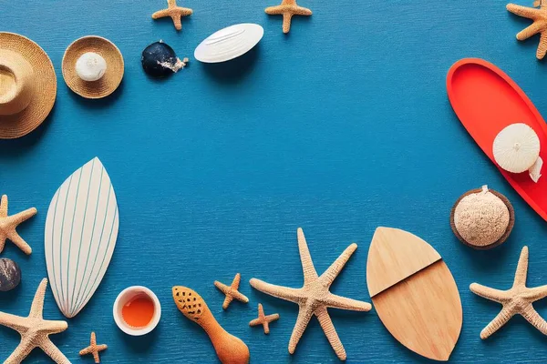 a blue surface with various items made out of wood and shells on it