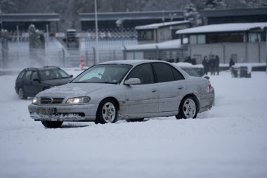 12-12-2022 Riga, Letonya. Bir binanın yakınına bir araba park edilmiş. Bir otoparkta insanlar yürüyor.. .