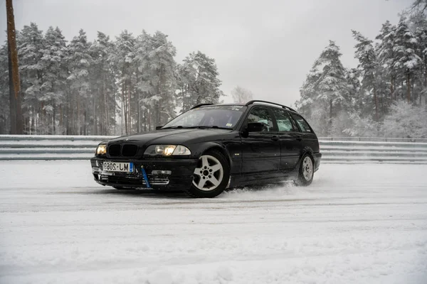 2022 Ryga Łotwa Czarny Samochód Przejeżdżający Przez Pokrytą Śniegiem Drogę — Zdjęcie stockowe