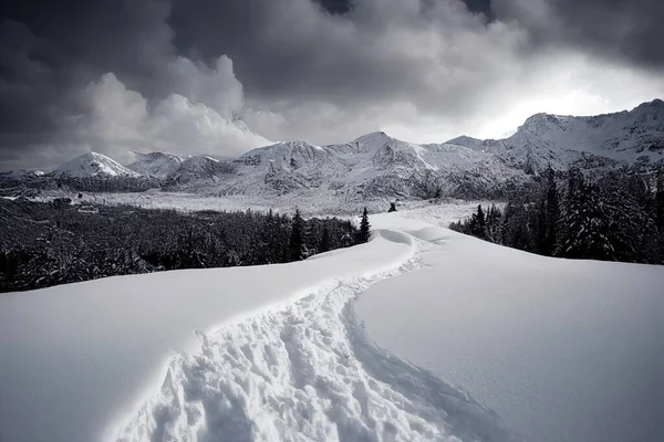 a snow covered mountain with a trail going through it and a cloudy sky above it with mountains in the distance. .