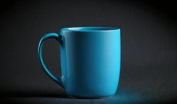 a blue coffee mug sitting on a black surface with a black background.
