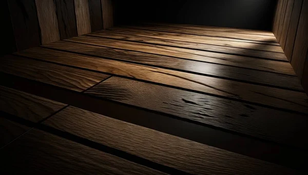a dark room with a wooden floor and a light shining on the floor.