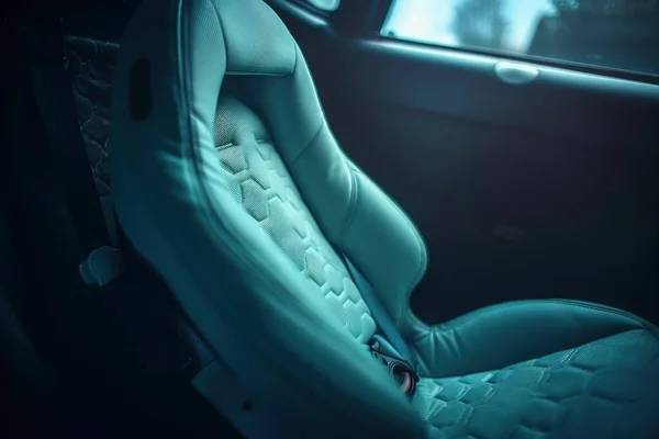 the interior of a car with a blue leather seat cover.