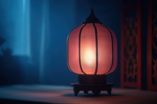 a red lantern sitting on top of a wooden table next to a window.