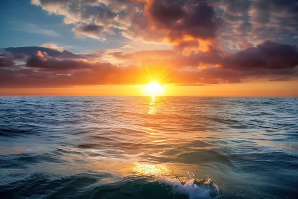 the sun is setting over the ocean with a wave in the foreground and clouds in the sky over the water and in the horizon.