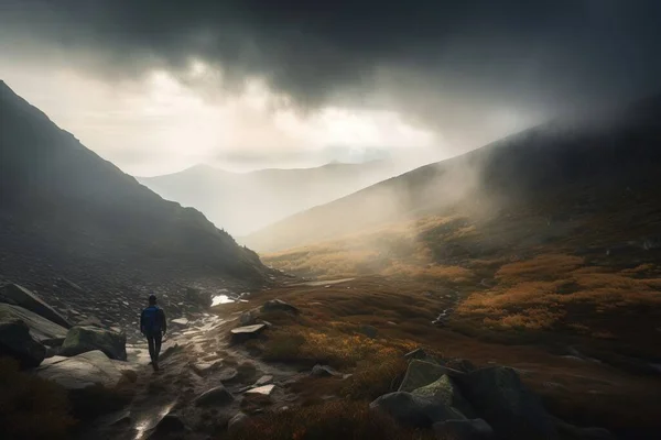 a person walking on a path in a mountain valley under a dark sky with a dark cloud in the sky and a person walking on a trail in the grass.