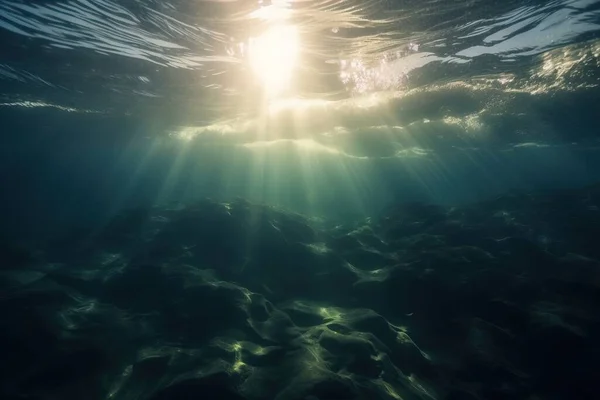 the sun shines through the water on a sunny day in the ocean, as seen from the bottom of the water, as the sun beams of light shine through the water.