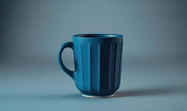 a blue coffee cup sitting on top of a gray table.
